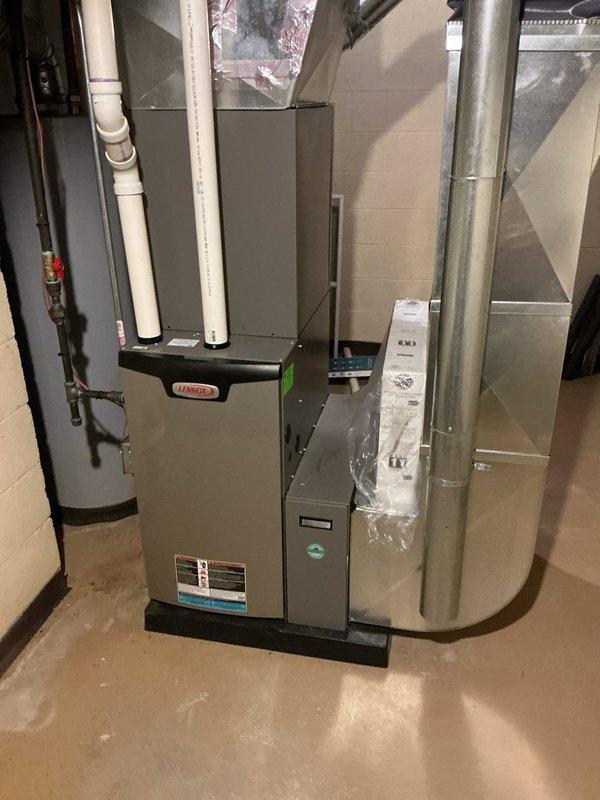 Completed comprehensive furnace and air conditioning maintenance on residential HVAC system installed in basement utility area. Performed standard seasonal maintenance procedures including inspection of gray metal furnace unit, air handler components, PVC condensate drainage lines with multiple joints and fittings, copper refrigerant piping with associated valves and connections, and metallic ductwork system including rectangular plenum and round supply ducts. All equipment found operating within normal parameters with no deficiencies noted requiring immediate attention.