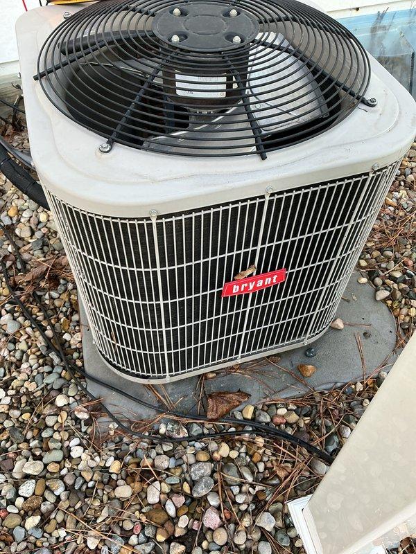 Performed annual cooling maintenance on Bryant outdoor condensing unit. Measured and recorded electrical parameters showing 36.37 amps and 232.5 volts, confirming proper system operation. Inspected condenser coil, fan assembly, and surrounding area, noting debris accumulation around unit base that was addressed during service.