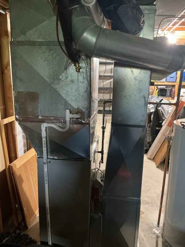 Completed annual cooling maintenance on residential HVAC system. Inspected evaporative cooler unit on rooftop, finding heavily soiled mesh filter pad with significant dust and debris accumulation. Checked indoor air handler unit in basement, verifying proper operation of furnace, ductwork connections, and condensate drainage system. All components operational with filter requiring replacement or cleaning to maintain optimal airflow and system efficiency.