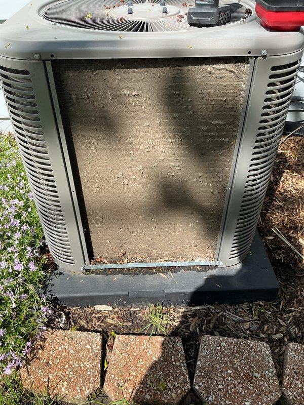 Completed annual cooling maintenance on residential heat pump system. Removed access panel and inspected interior compartment, noting significant accumulation of dirt, dust, and grime on internal surfaces with visible streaking patterns from condensation. Cleaned condenser coils, checked refrigerant lines, verified fan motor operation, and inspected electrical connections. Unit operational and ready for cooling season.