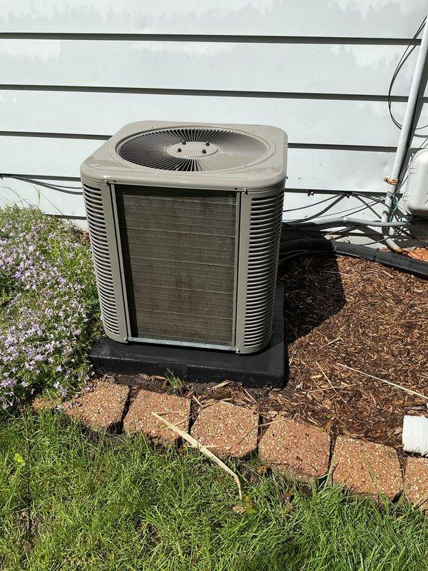 Completed annual cooling maintenance on residential heat pump system. Removed access panel and inspected interior compartment, noting significant accumulation of dirt, dust, and grime on internal surfaces with visible streaking patterns from condensation. Cleaned condenser coils, checked refrigerant lines, verified fan motor operation, and inspected electrical connections. Unit operational and ready for cooling season.