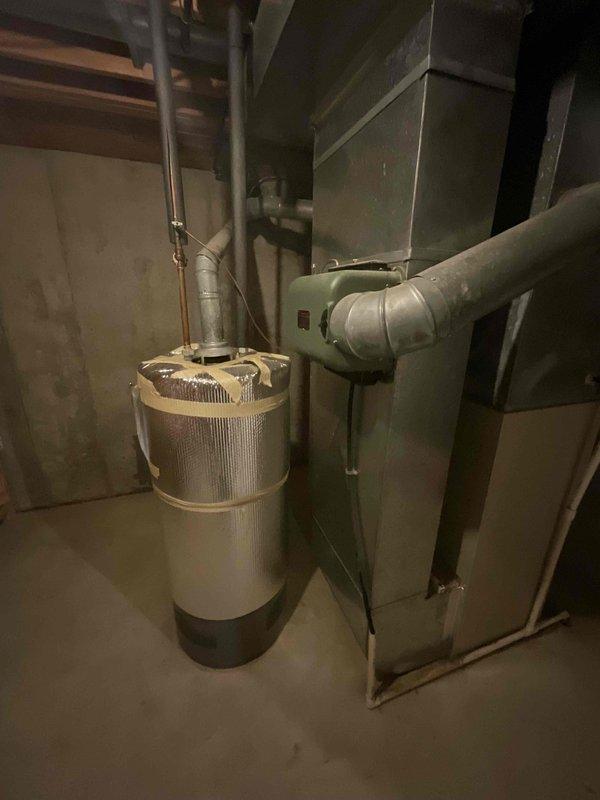 Conducted comprehensive assessment of existing HVAC system in basement mechanical room for complete furnace replacement estimate. System evaluation revealed aging furnace unit with connected humidifier component, metal ductwork, and plenum assembly showing typical wear consistent with end-of-service-life equipment. Documented current installation configuration including duct connections, copper piping, and mechanical room layout to provide accurate replacement specifications and equipment sizing recommendations for new high-efficiency system installation.
