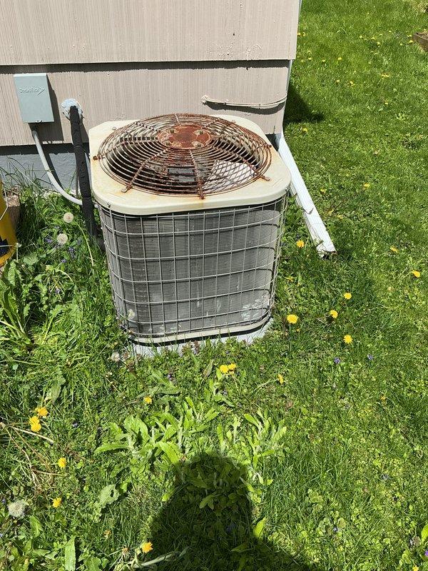 Completed scheduled preventive maintenance on residential air conditioning condenser unit. Performed comprehensive system inspection, cleaned condenser coils, checked refrigerant levels, tested electrical connections, and verified proper operation of all components. Unit operational and ready for cooling season, though fan guard shows significant rust and corrosion that may require future attention.