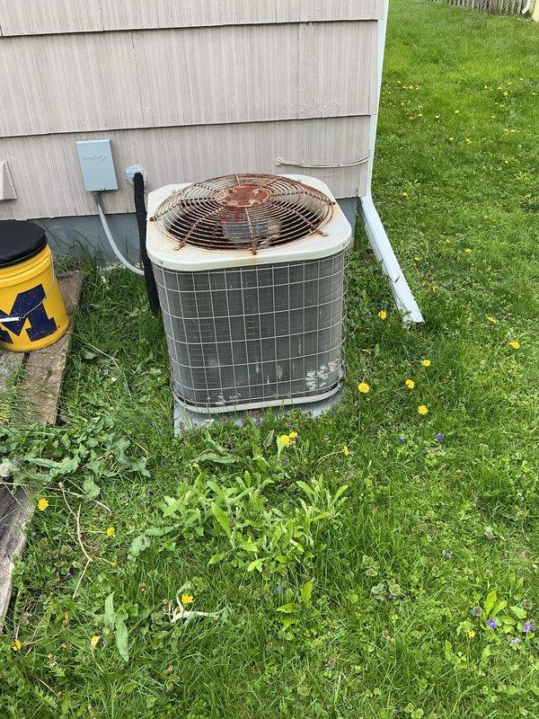 Completed scheduled preventive maintenance on residential air conditioning condenser unit. Performed comprehensive system inspection, cleaned condenser coils, checked refrigerant levels, tested electrical connections, and verified proper operation of all components. Unit operational and ready for cooling season, though fan guard shows significant rust and corrosion that may require future attention.