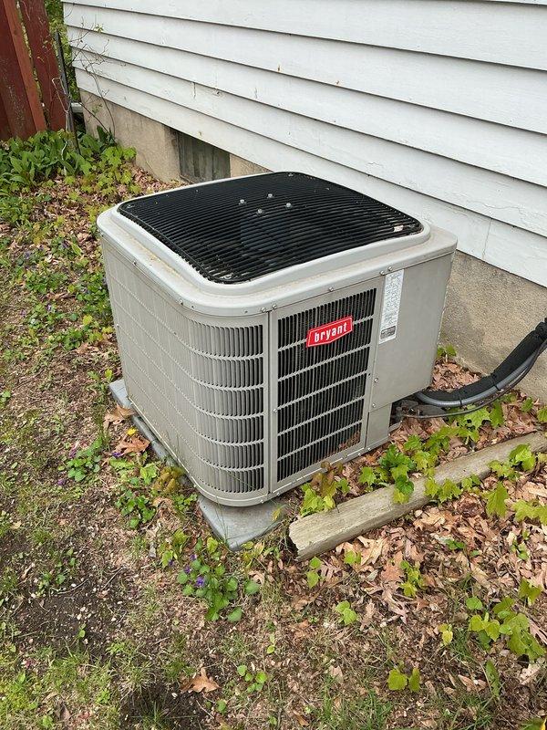 Completed annual HVAC maintenance on Bryant brand outdoor condensing unit. Inspected unit exterior condition, verified proper placement on concrete pad, and documented vegetation growth around unit perimeter requiring customer attention for adequate airflow clearance. Noted accumulation of leaves and debris around base of equipment that could restrict airflow if not maintained. Photographed refrigerant line set routing and overall installation for service records. Recommended customer address vegetation management and debris removal around unit to maintain manufacturer specifications for clearance and ensure optimal system performance.