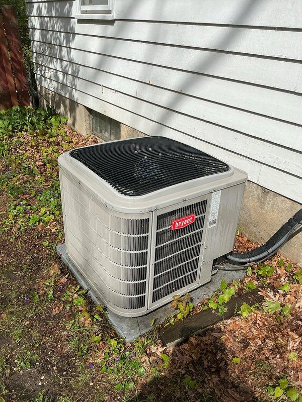 Completed annual HVAC maintenance on Bryant brand outdoor condensing unit. Inspected unit exterior condition, verified proper placement on concrete pad, and documented vegetation growth around unit perimeter requiring customer attention for adequate airflow clearance. Noted accumulation of leaves and debris around base of equipment that could restrict airflow if not maintained. Photographed refrigerant line set routing and overall installation for service records. Recommended customer address vegetation management and debris removal around unit to maintain manufacturer specifications for clearance and ensure optimal system performance.