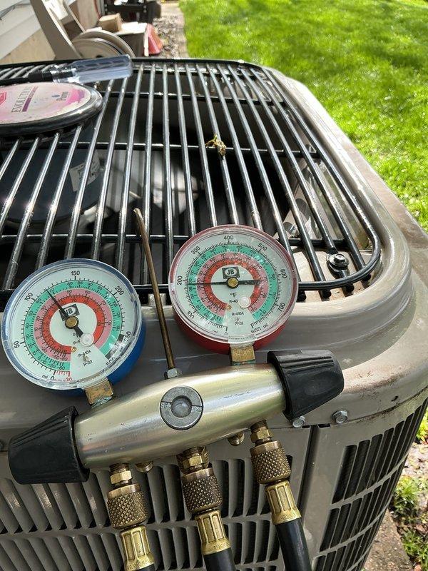 # HVAC Maintenance - ACM Completed

Performed comprehensive air conditioning maintenance on residential outdoor condensing unit. Connected refrigerant manifold gauge set to service ports and recorded system pressures to verify proper refrigerant charge levels. Measured electrical parameters including amperage draw of 58.3 amps and voltage reading of 14.8 using digital clamp meter to ensure compressor and fan motor were operating within manufacturer specifications. Inspected all electrical connections at control board, confirming proper wire terminations and component functionality. System operating normally with pressures and electrical readings within acceptable ranges. Unit showing no signs of refrigerant leaks or mechanical issues. Routine maintenance completed successfully.