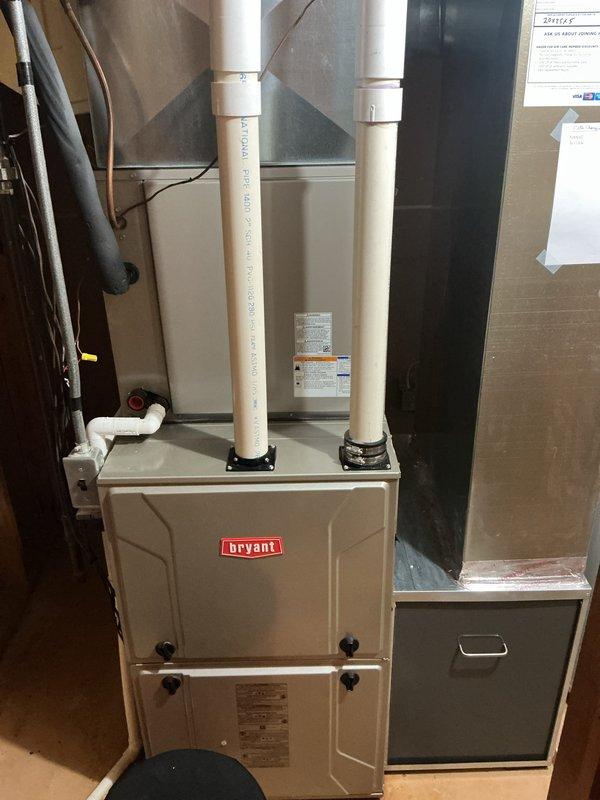 Performed annual HVAC maintenance on Bryant furnace system in residential mechanical room. Conducted thorough inspection of heat exchanger assembly, verified integrity of U-bend tubes and mounting connections, examined PVC venting system and ductwork connections, and documented system condition through photographic records. All components found operating within normal parameters with proper airflow and no visible defects noted in heat exchanger or cabinet assembly.