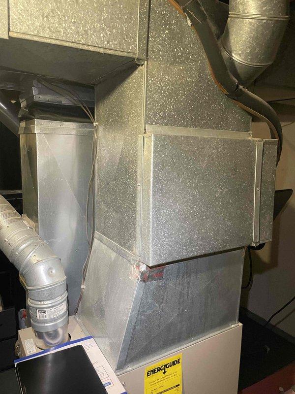 Provided comprehensive estimate for complete HVAC system replacement in basement location. Evaluated existing ancient air conditioning unit currently non-operational and assessed gray metallic air handler with rigid insulated ductwork and flexible duct connections. Prepared replacement proposal for new air conditioning system and natural gas furnace to restore climate control functionality to the residence.