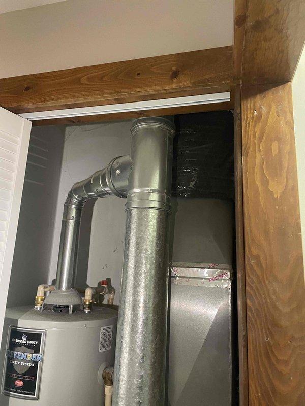 Completed site assessment for new air conditioning system installation at residential property. Evaluated attic access point via hallway ceiling opening and inspected existing utility closet containing water heater and ventilation ductwork to determine optimal equipment placement and routing for outdoor A/C unit installation. Documented existing infrastructure including galvanized metal ductwork, utility closet dimensions, and attic access configuration to prepare comprehensive estimate for new HVAC system installation with exterior condenser unit placement.