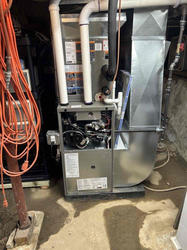 Responded to carbon monoxide alarm activation with "move to fresh air" alert at residence with one-year-old gas furnace and water heater. Performed comprehensive combustion analysis on furnace using digital analyzer, which revealed elevated carbon monoxide levels of 16-29 PPM in flue gas with 9.3% oxygen content and combustion efficiency reading of 97.0%. Conducted thorough safety inspection of both gas-fired appliances, including visual examination of heat exchanger, burner assembly, and venting system components. Documented combustion readings and equipment conditions with photographs for service records.