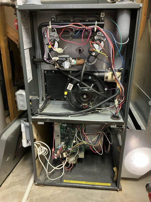 Responded to service call for furnace making unusual noise when heating system activated. Performed diagnostic inspection of 10+ year old furnace unit located in basement. Upon inspection, accessed internal components including burner assembly, blower motor, gas valve, and control board. Examined blower wheel and found accumulated debris on fan cage surfaces, which was determined to be the source of operational noise. Cleaned blower assembly and verified all electrical connections, gas valve operation, and control board functionality. System tested and confirmed proper operation with noise issue resolved.