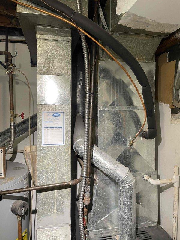 Conducted on-site assessment of non-operational air conditioning system located in basement mechanical room. Evaluated existing 8+ year old equipment, photographed current installation including refrigerant lines, ductwork connections, and air handler configuration. Provided replacement estimate for complete AC system upgrade, documenting existing copper linesets, PVC condensate drainage, and confined space installation requirements for proper equipment sizing and installation planning.