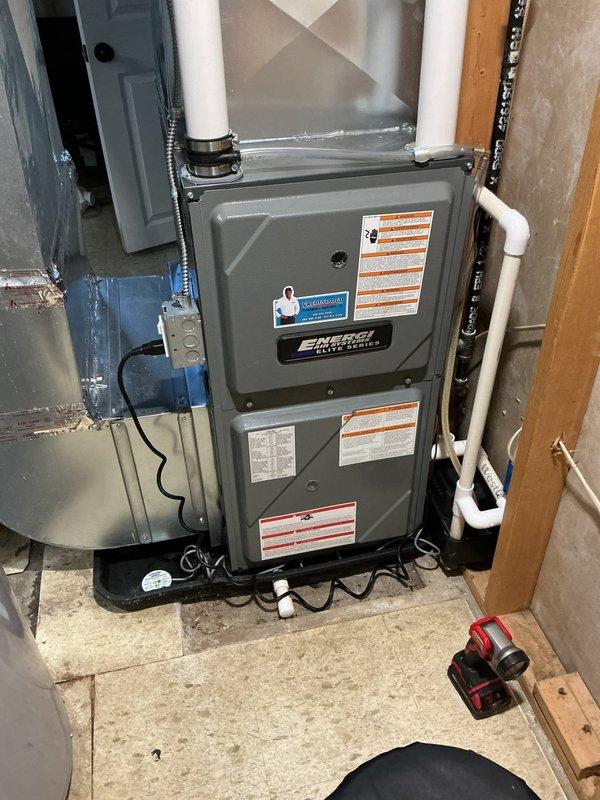Responded to no-heat call on 3-year-old Energy Elite Series furnace displaying red indicator light. Upon arrival, found furnace in safety lockout mode due to moisture exposure from adjacent water softener leak. Inspected unit for water damage and verified no internal moisture penetration into critical components. Checked condensate drain system, blower assembly, and electrical connections for water intrusion. Confirmed furnace control board triggered safety shutdown as designed to prevent electrical damage. Allowed unit adequate drying time and verified all safety sensors functioning properly. Reset furnace control system and cycled unit through complete heating sequence. Confirmed proper ignition, flame sensing, and blower operation with no fault codes present. Verified adequate airflow through supply and return ductwork. Advised homeowner that furnace safety systems operated correctly and unit sustained no permanent damage from moisture event. Recommended monitoring area for addition