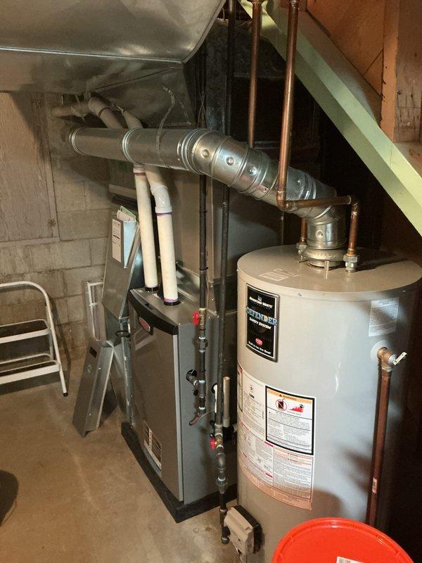 Completed annual cooling maintenance on residential HVAC system. Performed comprehensive inspection of indoor furnace unit located in basement utility area and outdoor condenser unit, verifying all components operational and properly connected. Documented equipment condition with photographs showing copper refrigerant lines, ductwork connections, and condenser coil in serviceable condition with no immediate repairs required.
