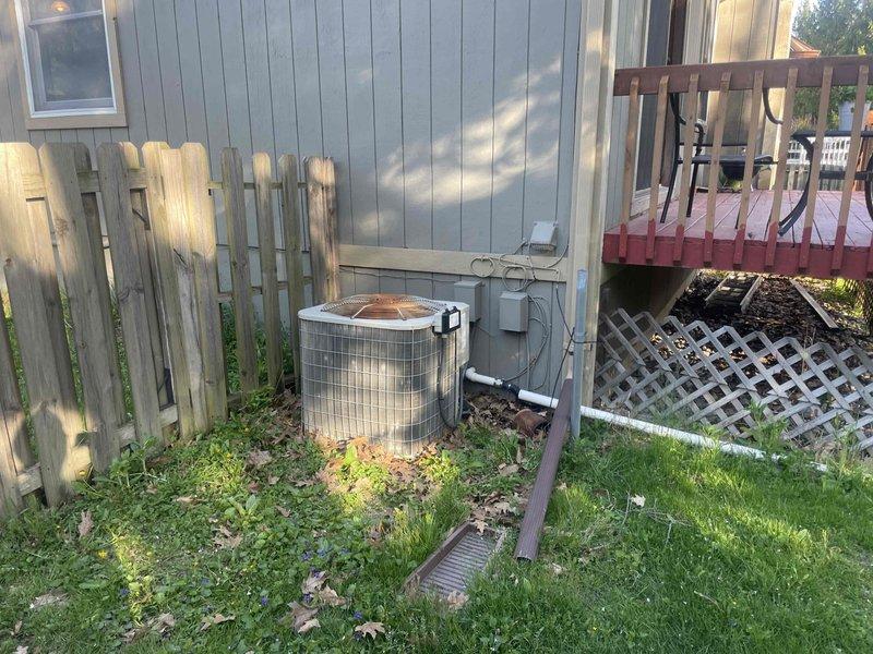 Provided estimate for replacement of 17-year-old non-functional air conditioning system with outdoor condenser unit located at exterior foundation and indoor air handler/ductwork installed in basement. Assessed existing natural gas furnace system and HVAC infrastructure including refrigerant lines, electrical connections, and metallic ductwork with plenum configuration to determine compatibility and replacement requirements for complete cooling system installation.