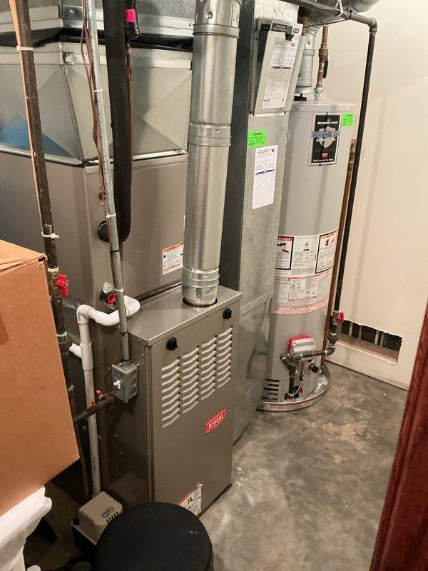 Completed annual cooling maintenance on Bryant residential HVAC system. Performed comprehensive inspection of furnace and air handler components, including heat exchanger examination which revealed normal dust accumulation consistent with system age and operation. Cleaned and inspected serpentine heat exchanger tubes, verified proper airflow pathways, and checked all accessible internal components for wear or damage. Inspected PVC condensate drainage system with red-handled valves for proper operation and clearances. Verified electrical connections at junction box and control panel. Examined all copper refrigerant lines and ductwork connections for secure mounting and proper insulation. Confirmed adequate equipment clearances and proper ventilation in utility room installation. System operating within normal parameters with no immediate service needs identified. Equipment showing typical wear patterns for age with no safety concerns noted. All components accessible for future maintenan