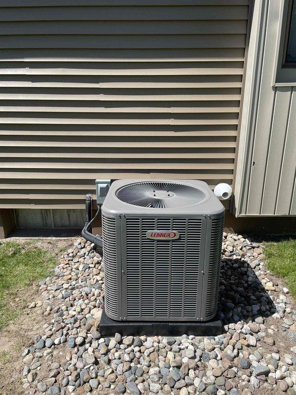 Completed full HVAC system installation including a 70,000 BTU furnace with left-side configuration, 2.5 ton Lennox air conditioning condensing unit, and humidifier. The outdoor AC unit was professionally mounted on a vibration-dampening pad over a gravel bed with proper drainage, and all refrigerant lines and electrical connections were completed. Reconnected existing components and verified system operation for both heating and cooling functionality.