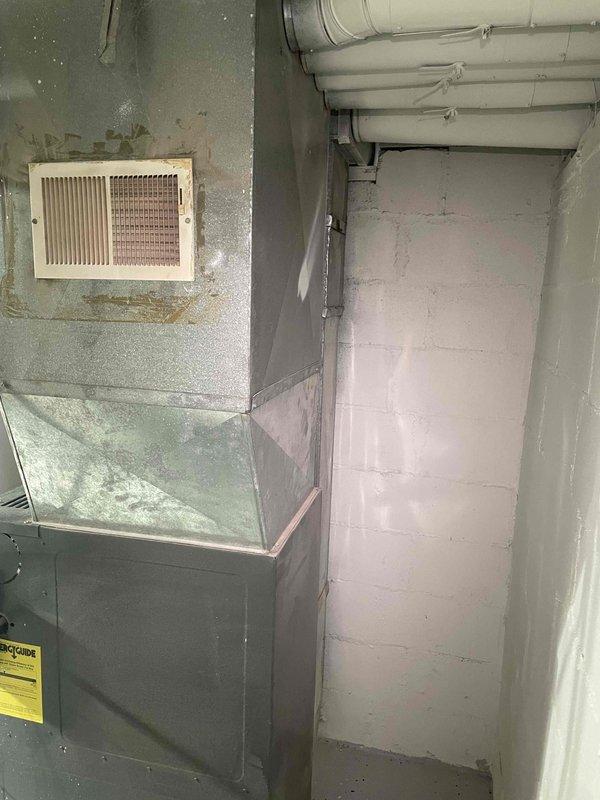 Provided estimate for BOGO furnace and air conditioning system replacement in basement location. Current furnace is non-operational and aged beyond serviceable life, with no existing air conditioning system present. Assessment included evaluation of existing gray metal furnace unit, return air vent configuration, and ductwork infrastructure to determine equipment specifications and installation requirements for complete HVAC system upgrade.