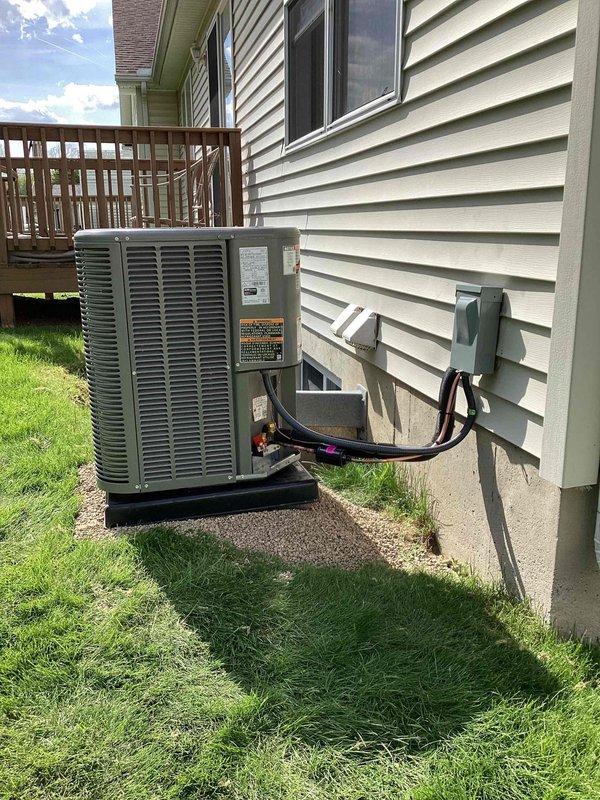 Completed full HVAC system installation including a 70,000 BTU furnace with humidifier and 2-ton air conditioning unit with rear discharge configuration. Installed new furnace in basement mechanical room on equipment platform with proper ductwork connections and sheet metal transitions to existing distribution system. Mounted outdoor condensing unit on concrete pad against exterior wall with refrigerant line set routed up vinyl siding, secured with appropriate brackets and insulation. Installed electrical disconnect box and completed all electrical connections per code requirements. Reconnected all necessary plumbing and drainage lines to equipment. System was tested for proper operation, refrigerant charge verified, and all safety controls confirmed functional. Installation completed under mechanical permit as specified.