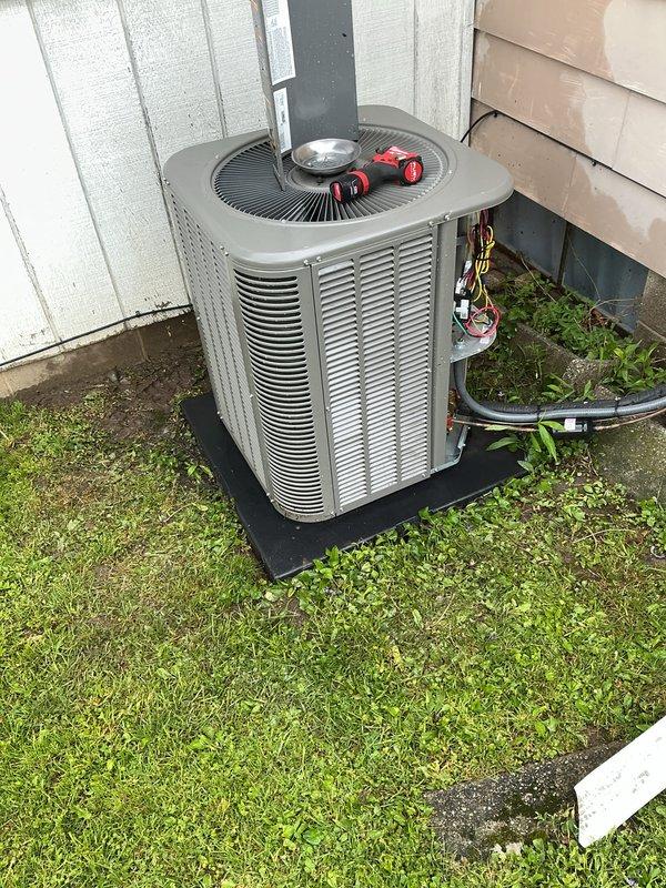 Completed routine air conditioning maintenance inspection on outdoor condensing unit. Unit found in operational condition with proper airflow through louvers and fan grille functioning normally. Refrigerant lines inspected and found secure with insulation intact. Electrical disconnect and conduit connections verified. Customer advised that air filter replacement is needed to maintain system efficiency and indoor air quality.