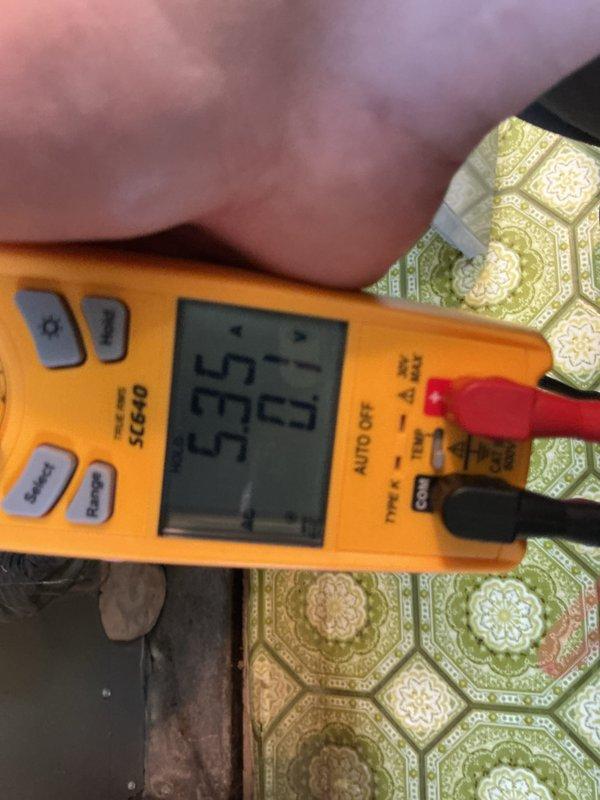 Completed comprehensive 5-year ComfortGuard maintenance visit on residential HVAC system. Performed electrical diagnostics using digital multimeter, recording voltage readings at 55 volts to verify proper system operation and electrical component functionality. Inspected and serviced air handler unit, including removal and evaluation of air filtration media. Examined evaporator coil assembly and refrigerant line connections, noting copper tubing configuration and insulation integrity. All system components tested within normal operating parameters. Unit returned to full operational status with no deficiencies noted.