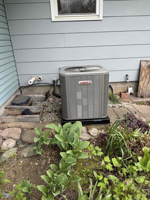 Completed full HVAC system installation consisting of a 70,000 BTU Lennox furnace and 2.5 ton Lennox air conditioning unit. Installed furnace in basement mechanical room on platform with proper venting and PVC condensate drainage lines. Mounted outdoor condenser unit on rear exterior wall with base platform on existing paver patio, connected refrigerant lines through wall penetration. Reconnected all electrical and gas connections, verified proper airflow, tested system operation, and confirmed heating and cooling functionality per manufacturer specifications.
