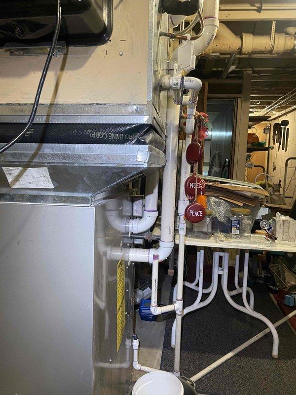 Conducted on-site evaluation of 16-year-old furnace system experiencing condensation issues beneath unit. Assessed existing HVAC equipment and extensive PVC condensate drainage system in mechanical room. Provided comprehensive replacement estimate for new furnace installation to address moisture concerns and aging equipment failure.