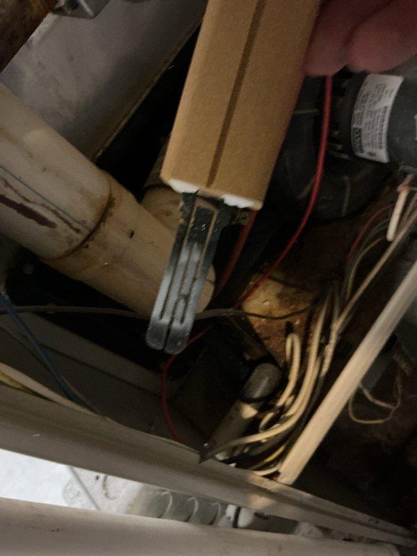 Responded to no-heat call for furnace with pilot light failure. Upon arrival, accessed furnace unit in confined space and performed diagnostic inspection of gas heating system. Inspected pilot assembly, gas valve, thermocouple, and related safety controls. Examined electrical wiring connections and verified proper voltage to system components. Assessed condensate drainage system and checked for blockages or overflow conditions that could trigger safety shutoffs. Documented equipment condition through photographic documentation showing furnace installation, gas piping, electrical connections, and drainage components within mechanical space. Identified issue preventing pilot ignition and completed necessary repairs to restore heat to residence.
