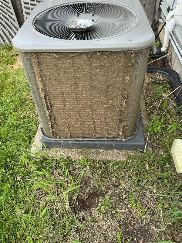 Completed annual cooling maintenance on outdoor condensing unit. Condenser coils were heavily soiled with accumulated dirt, dust, and debris, significantly restricting airflow through the fin surfaces. Thoroughly cleaned and degreased exterior coil fins to restore proper heat transfer efficiency. Removed debris buildup from base pan including leaves, twigs, and organic matter. Inspected fan operation and verified proper motor function. Unit operational upon completion with improved airflow and heat rejection capability.