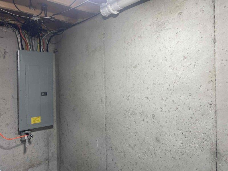 Conducted site assessment for new Kohler whole home generator installation. Evaluated basement utility area to determine optimal equipment placement, electrical service capacity, and required infrastructure modifications. Documented existing electrical panel configuration with multiple circuit wiring and conduit routing. Assessed concrete floor conditions, available clearances, and proximity to existing plumbing and mechanical systems including sump pump pit and drainage infrastructure. Identified suitable location for generator transfer switch installation and determined pathway for required electrical conduit runs from main service panel to proposed exterior generator pad location.