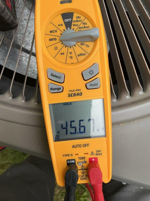 Completed annual HVAC maintenance on outdoor condensing unit. Performed electrical diagnostics using digital multimeter, measuring amperage draw at 6.19A and voltage readings, confirming system operating within normal parameters. Verified compressor performance with additional amperage reading of 456.7A during startup conditions. Inspected condenser coil fins and overall unit condition. Replaced air filter as scheduled maintenance item. Unit tested and left in proper working order for continued cooling season operation.