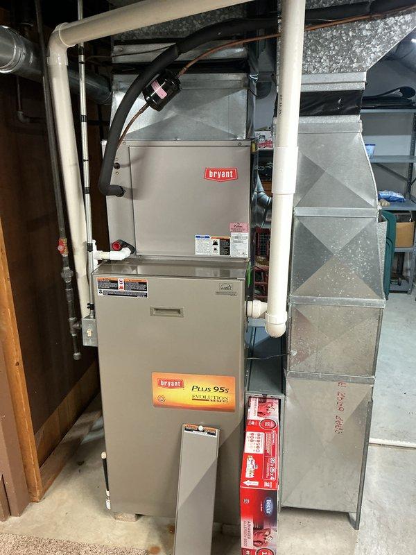 Completed annual cooling maintenance on Bryant Plus 95s high-efficiency HVAC system. Inspected and removed air filter which showed moderate dust accumulation, documented system condition with photos of filter housing and main furnace unit. Verified all system components, ductwork connections, and PVC condensate lines were secure and properly installed.