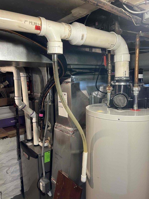 Responded to callback for reported drain leak following recent maintenance. Upon inspection, identified leak originating from condensate drain system connected to HVAC unit. Examined PVC drainage piping, connections, and trap assembly in utility area. Verified proper drain line pitch and cleared any blockages. Tightened fittings at connection points and tested system operation to confirm leak was resolved and condensate flowing properly through drain line without further issues.