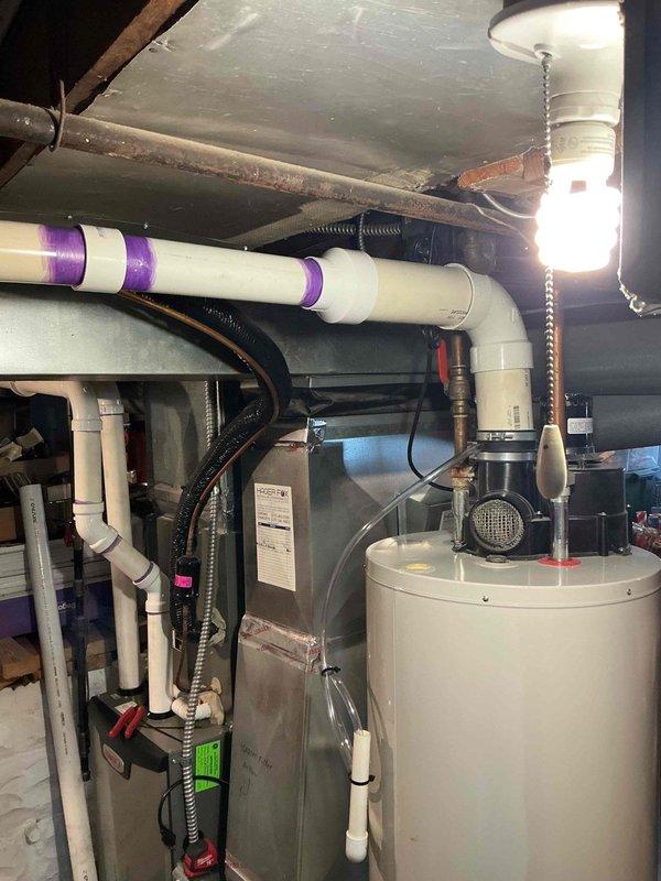 Responded to callback for reported drain leak following recent maintenance. Upon inspection, identified leak originating from condensate drain system connected to HVAC unit. Examined PVC drainage piping, connections, and trap assembly in utility area. Verified proper drain line pitch and cleared any blockages. Tightened fittings at connection points and tested system operation to confirm leak was resolved and condensate flowing properly through drain line without further issues.