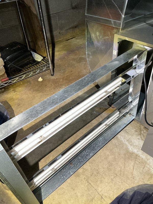 Completed annual cooling maintenance inspection and filter replacement. Accessed evaporator compartment housing and replaced dirty pleated air filter showing significant dust accumulation and discoloration at edges. Documented equipment condition with photos for service records.