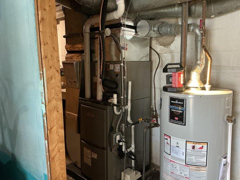 Completed full HVAC system installation in basement mechanical room, installing new 70,000 BTU gas furnace and 1.5-ton air conditioning unit in left-side configuration. Connected all necessary gas lines, electrical conduit, refrigerant lines, and integrated ductwork to existing distribution system. Reconnected all mechanical components and verified proper operation of complete heating and cooling system.