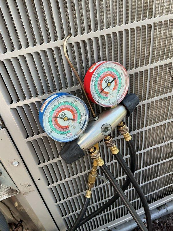 Performed annual cooling maintenance on outdoor condensing unit. Connected manifold gauges to measure refrigerant pressures and verified system operating parameters. Inspected condenser coil fins for proper airflow and noted unit condition for maintenance records.