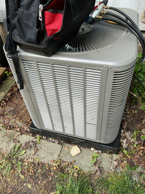 Performed annual cooling maintenance on residential air conditioning system. Inspected outdoor condenser unit, verified proper operation of compressor and condenser fan motor, checked refrigerant lines and connections for leaks, cleaned debris from around unit base, and confirmed system functionality. Unit operating within normal parameters with no issues identified.