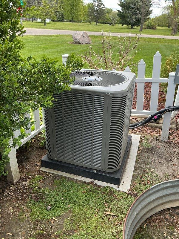 # HVAC Maintenance - ACM Completed

Performed comprehensive annual maintenance on a 1-year-old residential air conditioning system. Conducted thorough inspection of outdoor condenser unit, which was found to be properly installed on concrete pad with appropriate drainage and clearance from surrounding landscaping. Verified electrical connections and refrigerant lines were secure and properly insulated.

Completed full system tune-up including cleaning of condenser coils, inspection of fan motor and blades, verification of proper airflow through louvers, and testing of all electrical components. Checked refrigerant levels and system pressures to ensure optimal performance. Inspected mounting pad and concrete foundation for stability and proper positioning.

All components operating within manufacturer specifications. System demonstrated normal operation with no deficiencies noted. Unit maintained proper clearances from white picket fence and nearby landscaping. Recommended continued ann
