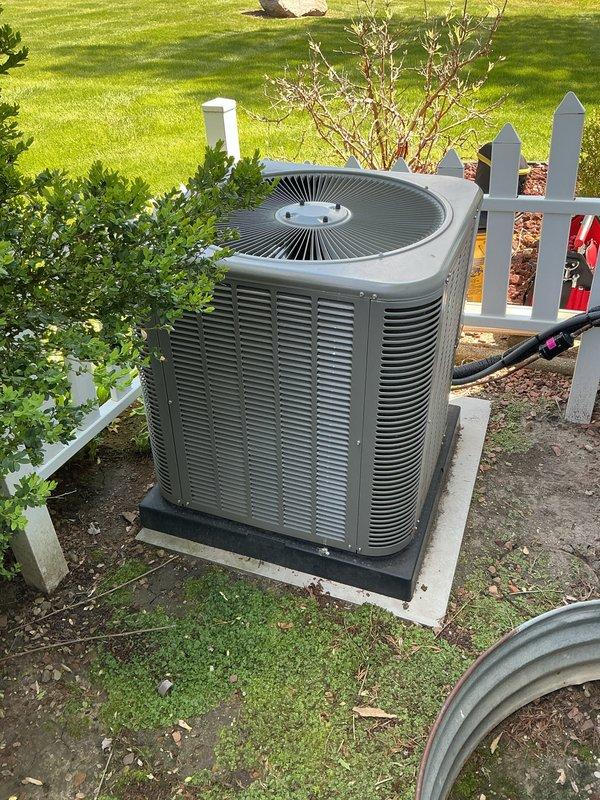 # HVAC Maintenance - ACM Completed

Performed comprehensive annual maintenance on a 1-year-old residential air conditioning system. Conducted thorough inspection of outdoor condenser unit, which was found to be properly installed on concrete pad with appropriate drainage and clearance from surrounding landscaping. Verified electrical connections and refrigerant lines were secure and properly insulated.

Completed full system tune-up including cleaning of condenser coils, inspection of fan motor and blades, verification of proper airflow through louvers, and testing of all electrical components. Checked refrigerant levels and system pressures to ensure optimal performance. Inspected mounting pad and concrete foundation for stability and proper positioning.

All components operating within manufacturer specifications. System demonstrated normal operation with no deficiencies noted. Unit maintained proper clearances from white picket fence and nearby landscaping. Recommended continued ann