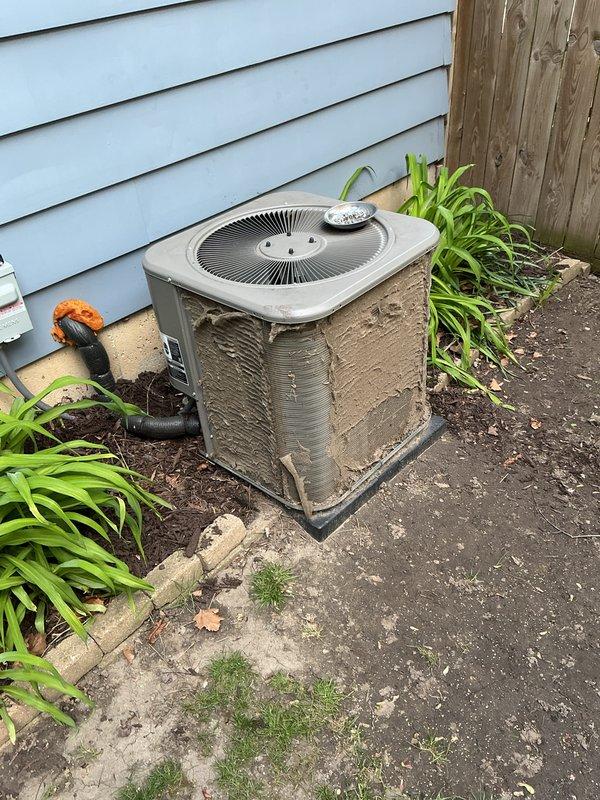 Completed annual cooling maintenance on residential outdoor condenser unit. Unit was heavily soiled with mud, dirt, and environmental debris on cabinet surfaces and surrounding area. Performed comprehensive cleaning of condenser coils, cabinet exterior, and concrete pad. Inspected all electrical connections, refrigerant lines, and mechanical components for proper operation. System tested and confirmed operational with no deficiencies identified.