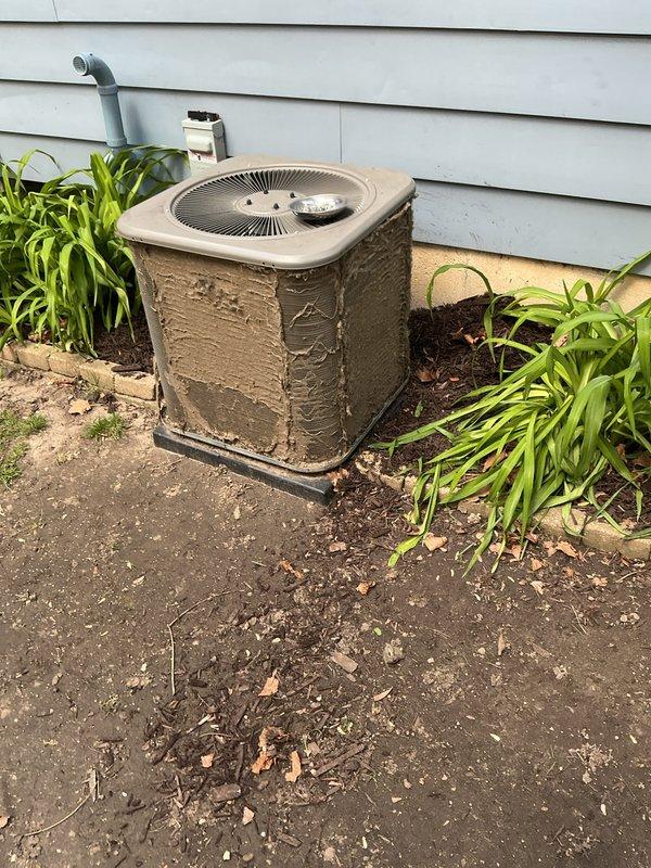 Completed annual cooling maintenance on residential outdoor condenser unit. Unit was heavily soiled with mud, dirt, and environmental debris on cabinet surfaces and surrounding area. Performed comprehensive cleaning of condenser coils, cabinet exterior, and concrete pad. Inspected all electrical connections, refrigerant lines, and mechanical components for proper operation. System tested and confirmed operational with no deficiencies identified.