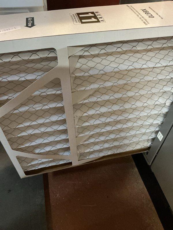 Completed annual cooling maintenance inspection on residential HVAC system. Inspected and photographed air filtration components, including pleated media filters with cardboard frames showing clean condition. Verified proper installation of filter assembly in ductwork system, confirmed adequate airflow through metallic duct components, and documented system configuration in mechanical room with galvanized ductwork and filter housing properly secured.