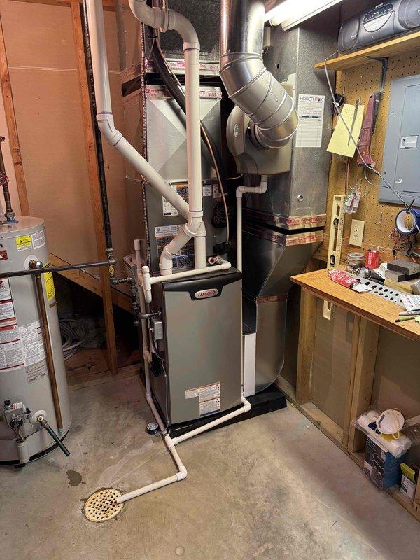 Completed full HVAC system installation in residential basement utility room consisting of new 70,000 BTU Lennox furnace with integrated humidifier and 2-ton air conditioning unit configured for right-side discharge. Installed all necessary PVC venting pipes routed vertically through structure, connected gas supply line with shutoff valve and pressure gauge, and established proper drainage connections. Configured insulated metallic ductwork connections to furnace plenum and verified proper airflow distribution. Reconnected existing electrical service to new equipment and ensured all safety controls operational. All mechanical permits obtained prior to installation and system tested for proper operation upon completion.