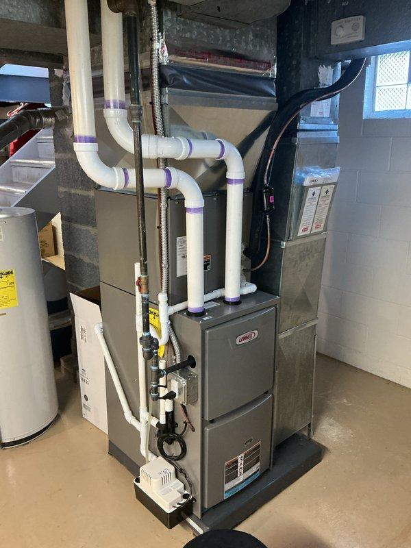 Completed annual HVAC maintenance on Lennox furnace system in basement utility area. Performed comprehensive inspection of unit, verified proper operation of all components, checked PVC venting system and condensate drainage lines for proper flow and connections. Documented equipment condition with photographs showing manufacturer specifications and safety labels clearly visible. All systems operating within normal parameters upon completion of maintenance visit.