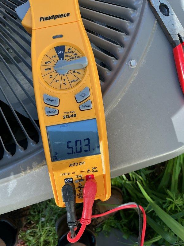 Completed annual cooling maintenance on HVAC system. Performed electrical diagnostics using multimeter, verified voltage readings at outdoor condenser unit registering 503V, inspected compressor and heat exchanger components, checked electrical connections and junction boxes in mechanical room, and documented equipment condition with photos. All components operating within normal parameters upon completion of maintenance inspection.