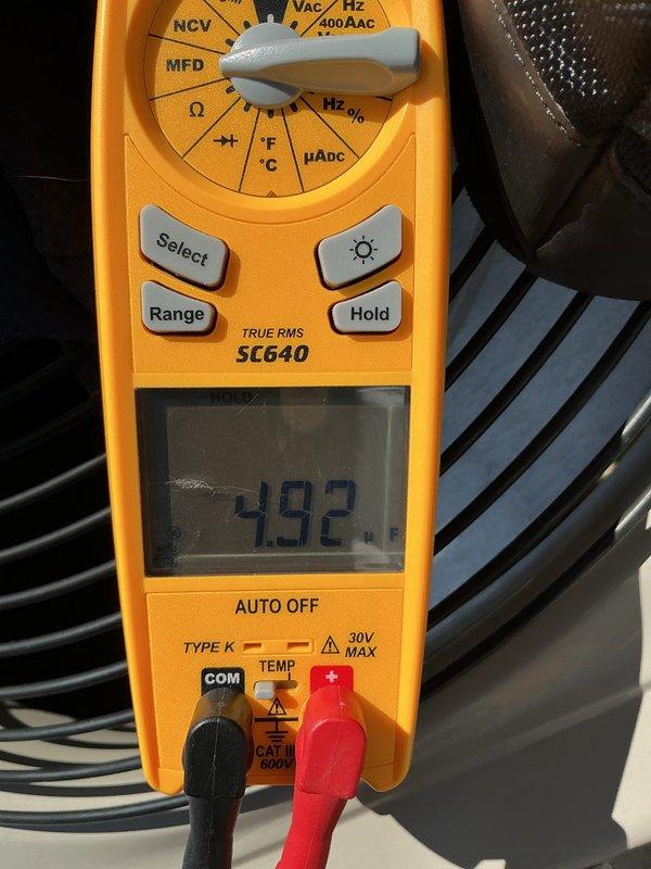 Performed annual cooling maintenance on residential air conditioning system. Conducted electrical diagnostics using digital multimeter to verify system operation and measure capacitance values. Unit requires replacement evaporative cooler pads to maintain optimal performance and efficiency.