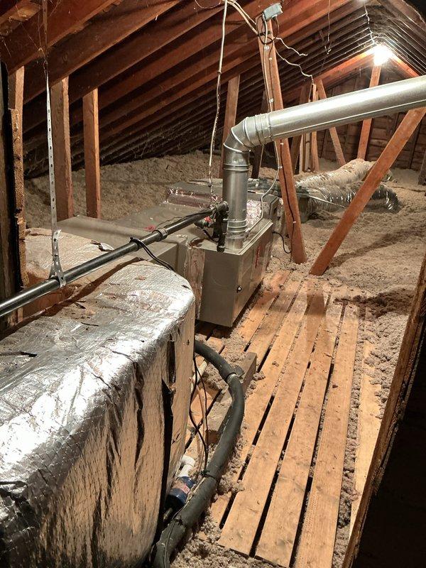Completed annual cooling maintenance on attic-installed air handler unit. Performed system inspection, changed air filter, and documented equipment condition with photos showing unit properly installed in attic space with adequate ductwork connections and insulation in place.