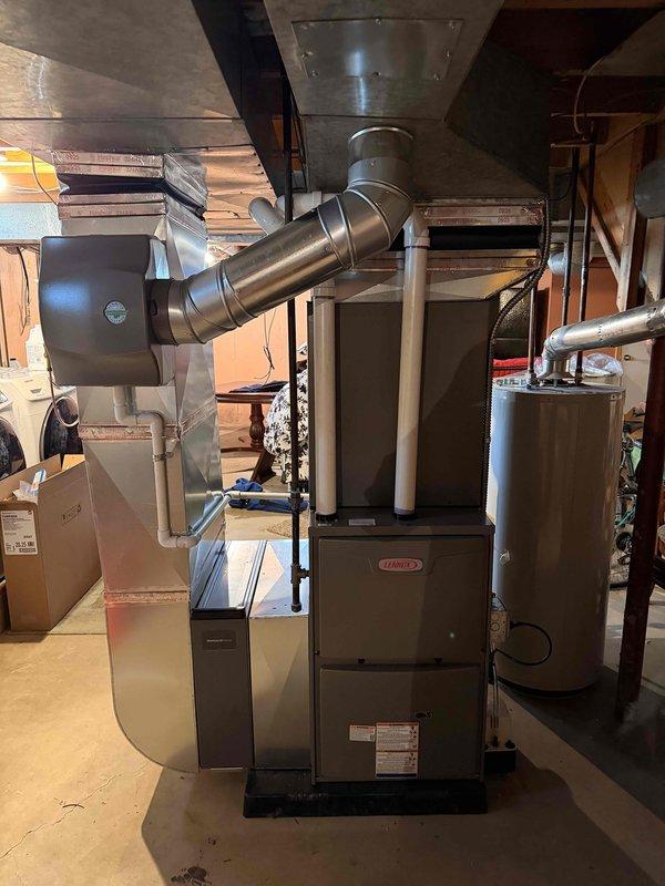 Completed full HVAC system installation including a Lennox 90,000 BTU high-efficiency furnace and 3-ton air conditioning unit with right-side configuration. Installed humidifier, ran refrigerant lines and electrical conduit along exterior siding to outdoor condenser unit positioned on concrete pad. Connected all ductwork including metallic transitions and elbow joints in basement mechanical room, verified proper airflow distribution, and reconnected all existing systems. Outdoor condenser professionally positioned with appropriate clearances from structure, all refrigerant lines insulated and secured. System startup completed with full operational testing of heating and cooling cycles, airflow verification, and thermostat calibration. All work performed to code with mechanical permits obtained prior to installation.